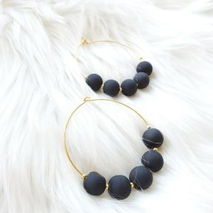 24 karat gold hoop earrings with black beads